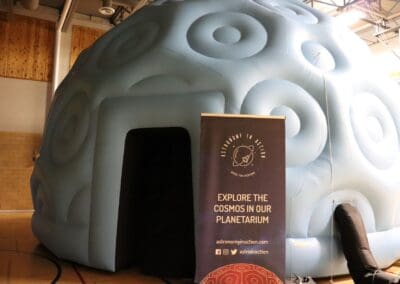 image shows the planetarium dome with Astronomy in Action Banner - a blue inflatable dome with an entrance door
