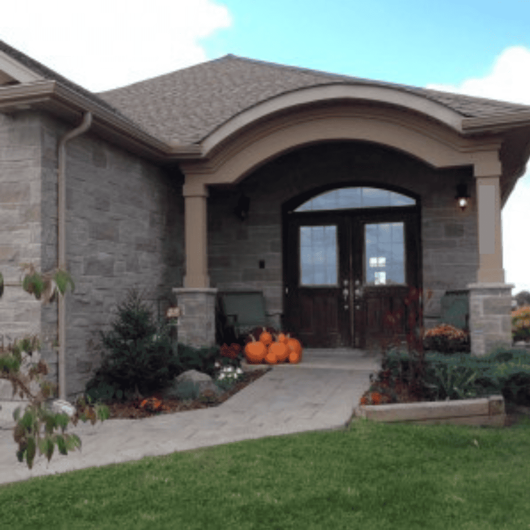 A beautiful accessible home with a ramp to the front door, decorated for fall